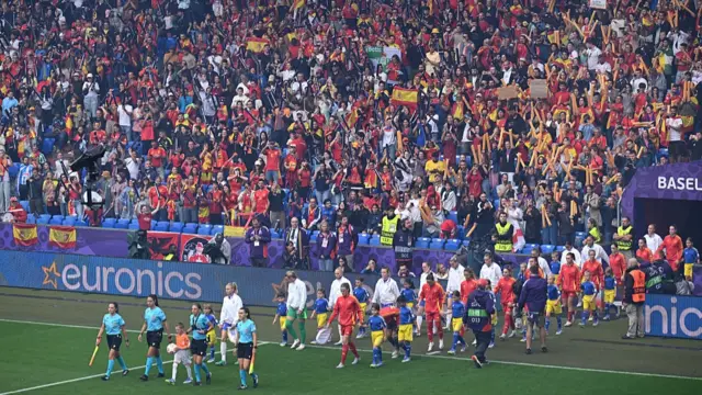 Match officials and players of Spain and England walk out prior to the UEFA Women's EURO 2025 Final match between England and Spain at St. Jakob-Park