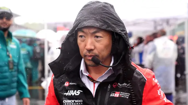 Ayao Komatsu in his coat in the rain at Spa.