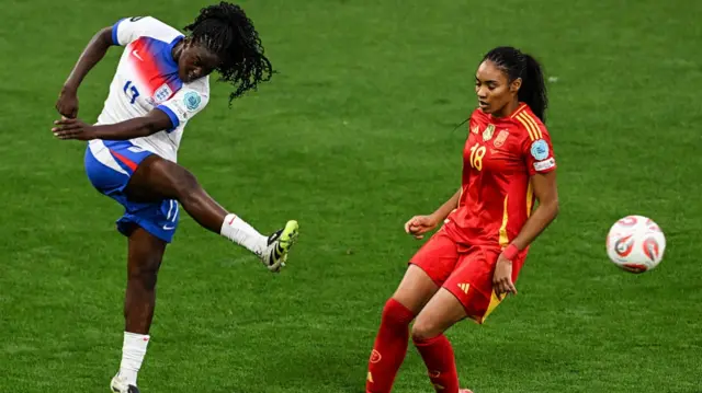 England's forward #17 Michelle Agyemang (L) shoots past Spain's forward #18 Salma Paralluelo during the UEFA Women's Euro 2025 final football match