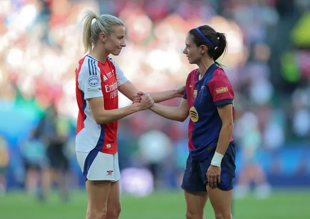 Leah Williamson shakes hands with Aitana Bonmati after Champions League final