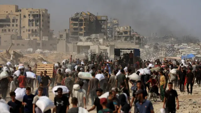 Palestinians carry aid supplies that entered Gaza through Israel