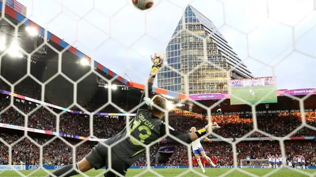 Chloe Kelly of England scores the team's fifth and winning penalty past Cata Coll of Spain in the penalty shoot out