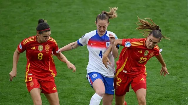 Keira Walsh of England is challenged by Mariona Caldentey and Patricia Guijarro of Spain during the UEFA Women's EURO 2025 Final match between England and Spain