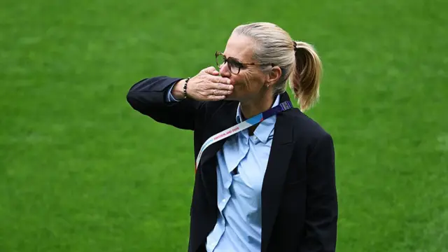 Sarina Wiegman, Head Coach of England, blows a kiss as she inspects the pitch