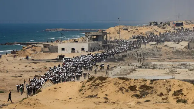 Palestinians carry aid supplies that entered Gaza through Israel