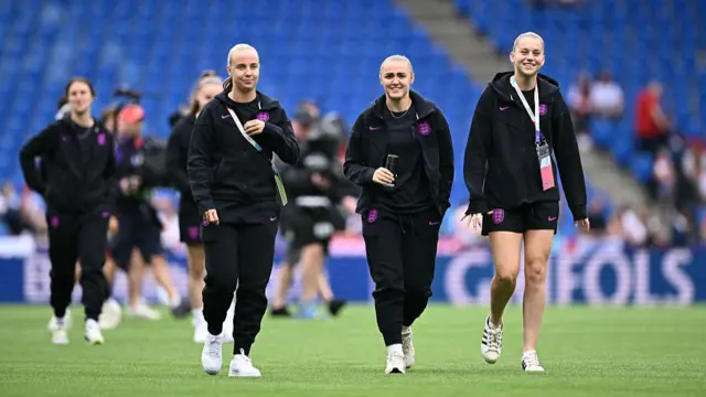 England's forward #09 Beth Mead, England's midfielder #08 Georgia Stanway and England's forward #23 Alessia Russo walks during the pitch inspection