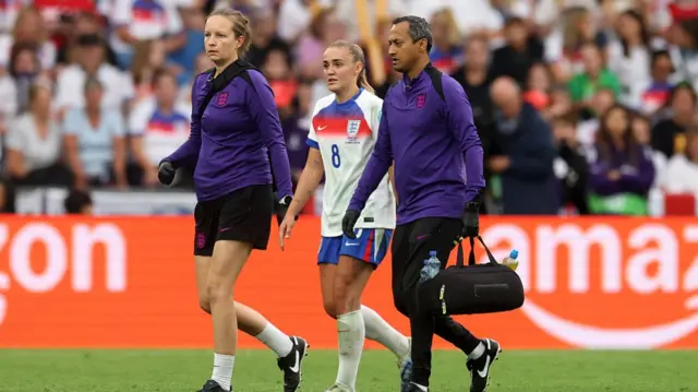 Georgia Stanway of England is escorted off the pitch by medical staff after picking up an injury