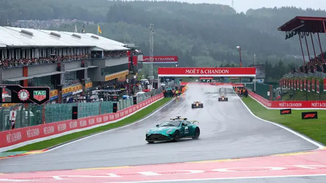The Safety Car leads the cars around the track at Spa.