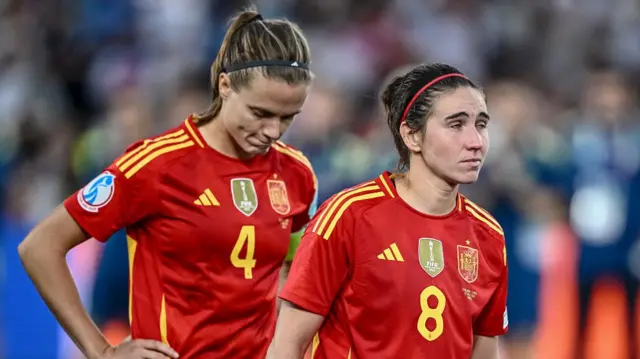 Irene Paredes of Spain and Mariona Caldentey of Spain look dejected after the UEFA Women's EURO 2025 Final match between England and Spain at St. JakobPark