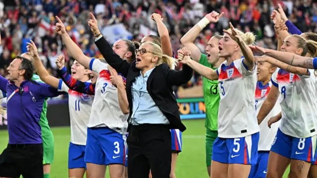 Sarina Wiegman (C), coach of England and players celebrate following the penalty shootout