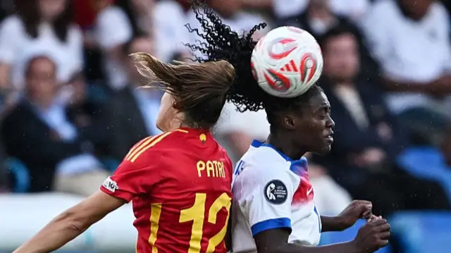 Patri Guijarro of Spain competes for the ball with Michelle Agyemang of England