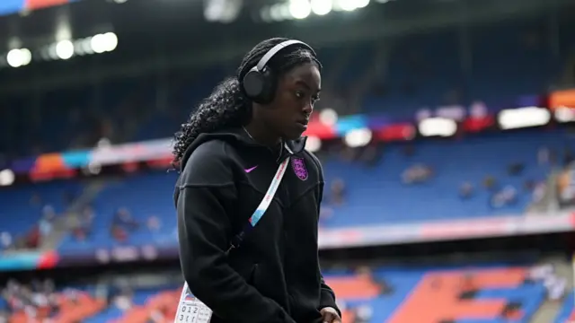 Michelle Agyemang of England inspects the pitch