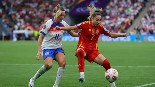 Olga Carmona of Spain holds off a challenge from Lauren Hemp of England during the UEFA Women's EURO 2025 Final match between England and Spain at St. Jakob-Park