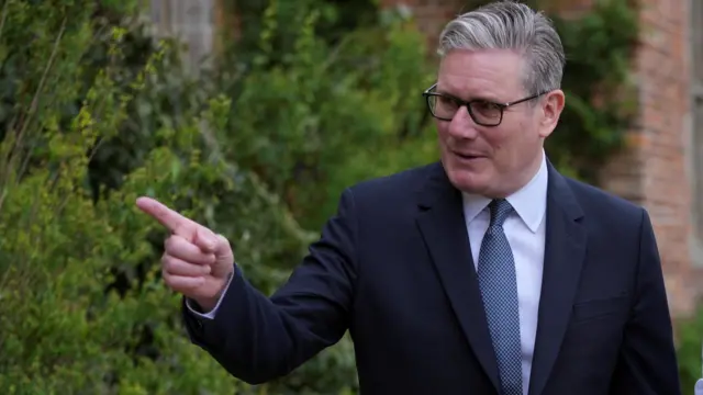 Britain's Prime Minister Keir Starmer points finger
