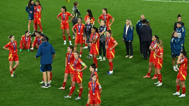 Players of Spain look dejected while wearing their runners up medals