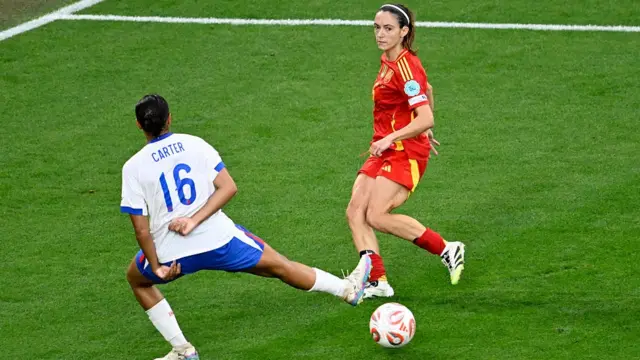 Aitana Bonmati of Spain and Jessica Carter of England battle for possession during the UEFA Women's EURO 2025 Final match between England and Spain at St. Jakob-Park
