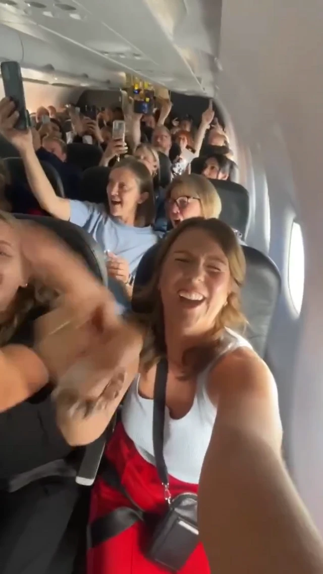 Fans singing on a plane to Switzerland