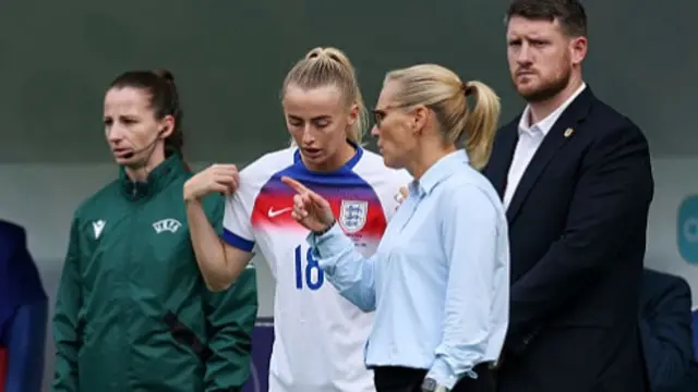 Chloe Kelly of England receives instructions from Sarina Wiegman, Head Coach of England, before coming on as a substitute for teammate Lauren James