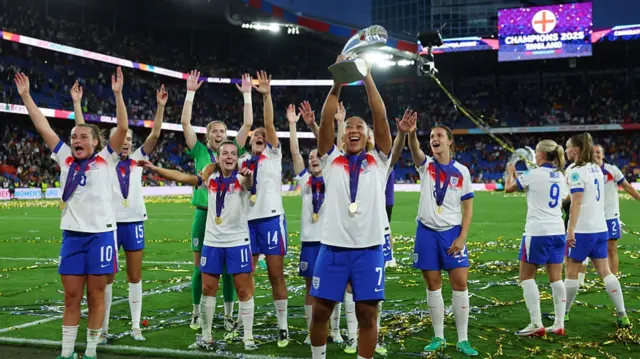 Lauren James of England celebrates with the UEFA Women's EURO trophy after her team's victory