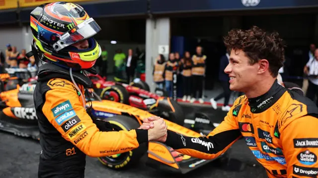 Oscar Piastri shakes the hand of teammates Lando Norris after the Belgian GP.