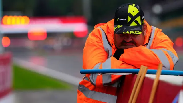 A marshal rests during a red flag at Spa