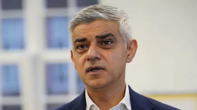 Headshot of Sadiq Khan looking at a point just beyond the camera