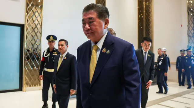 Thailand acting Prime Minister Phumtham Wechayachai walking