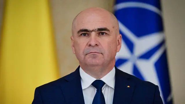 Ilie Bolojan in blue suit and tie