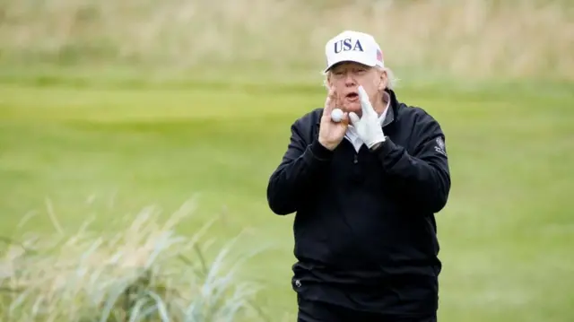 Trump speaks to the media while playing golf at the Trump Turnberry golf course on Sunday