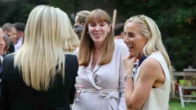 Deputy Prime Minister Angela Rayner (centre) speaks with Alex Greenwood (right)