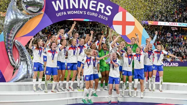 The English players celebrate with the trophy
