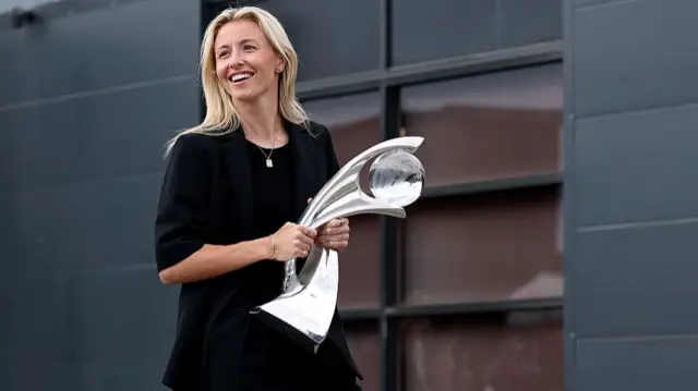 Leah Williamson of England carries the UEFA Women's EURO trophy after arriving at Southend Airport following the team's victory on July 28, 2025 in Southend, England. England defeated Spain in the UEFA Women's EURO 2025 Final to retain the trophy