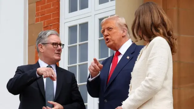 Starmer speaking to Trump as his wife stands next to them
