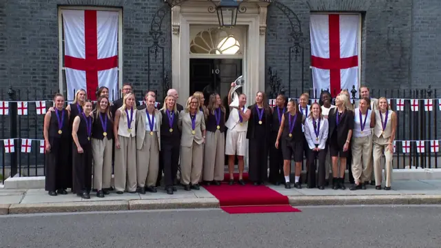 The Lionesses outside Downing Street holding the trophy aloft