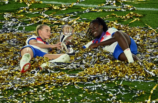Chloe Kelly and Michelle Agyemang celebrate with Euro 2025 trophy