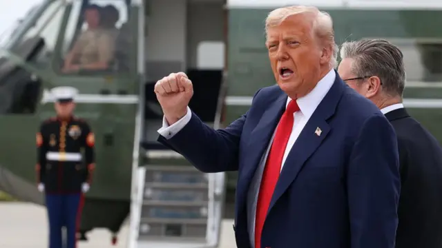 .S. President Donald Trump gestures before he boards Marine One, to travel to Trump International Golf Links Aberdeen