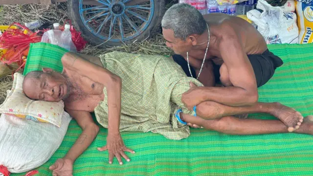 Meas Sovanarith (lying on the mat) has been thinking about his son on the frontlines