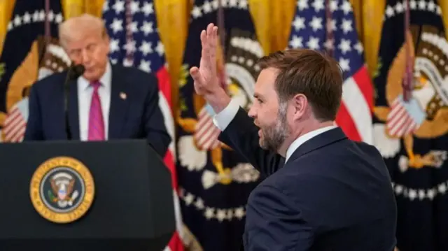 JD Vance waving with Trump in background