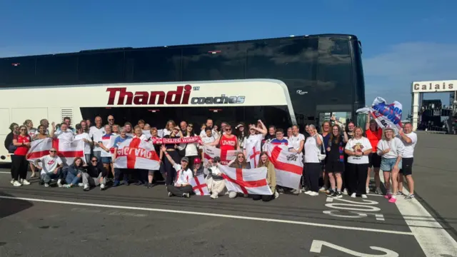 England fans pose for a photo outside a coach