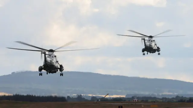 Marine One with U.S. President Donald Trump on board and a second helicopter fly, departing Lossiemouth, Scotland, Britain, July 28, 2025.