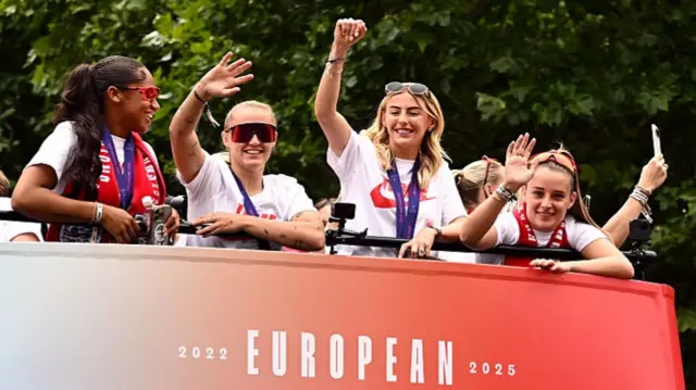 Georgia Stanway, Chloe Kelly and Ella Toone of England acknowledge the fans during the England Women's team victory parade