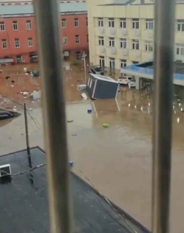 Alt text: this screengrab from the video shows flooding cased by heavy rainfall in Beijing