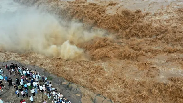 Aerial view of people visiting the roaring Hukou Waterfall on the Yellow River on July 27, 2025 in Jixian County, Linfen City, Shanxi Province