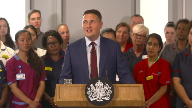 Streeting speaking at a podium