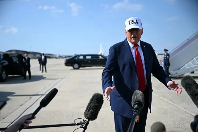 Donald Trump speaks to reporters before boarding Air Force One