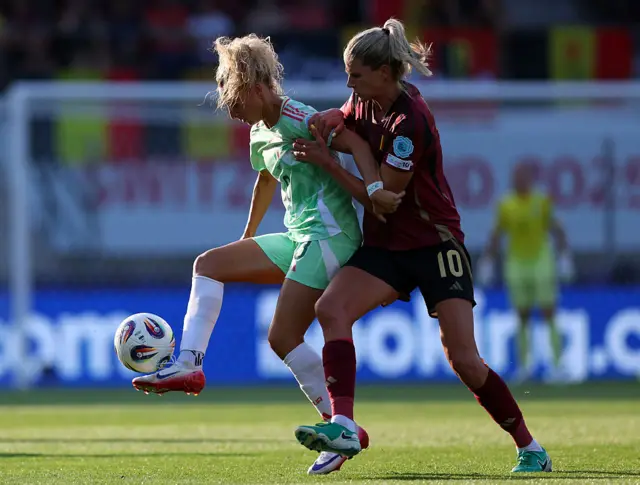 Emma Severini controls the ball whilst under pressure from Justine Vanhaevermaet