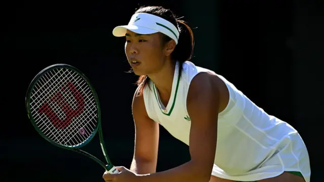 Mimi Xu prepares to receive a serve