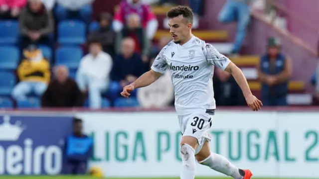 Andre playing wearing a white Penafiel kit