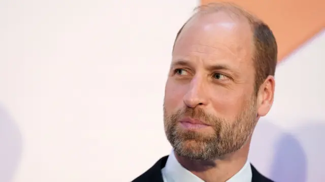Prince William looks off to the side