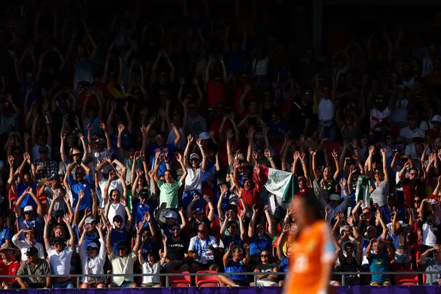 Fans perform a 'Mexican Wave'